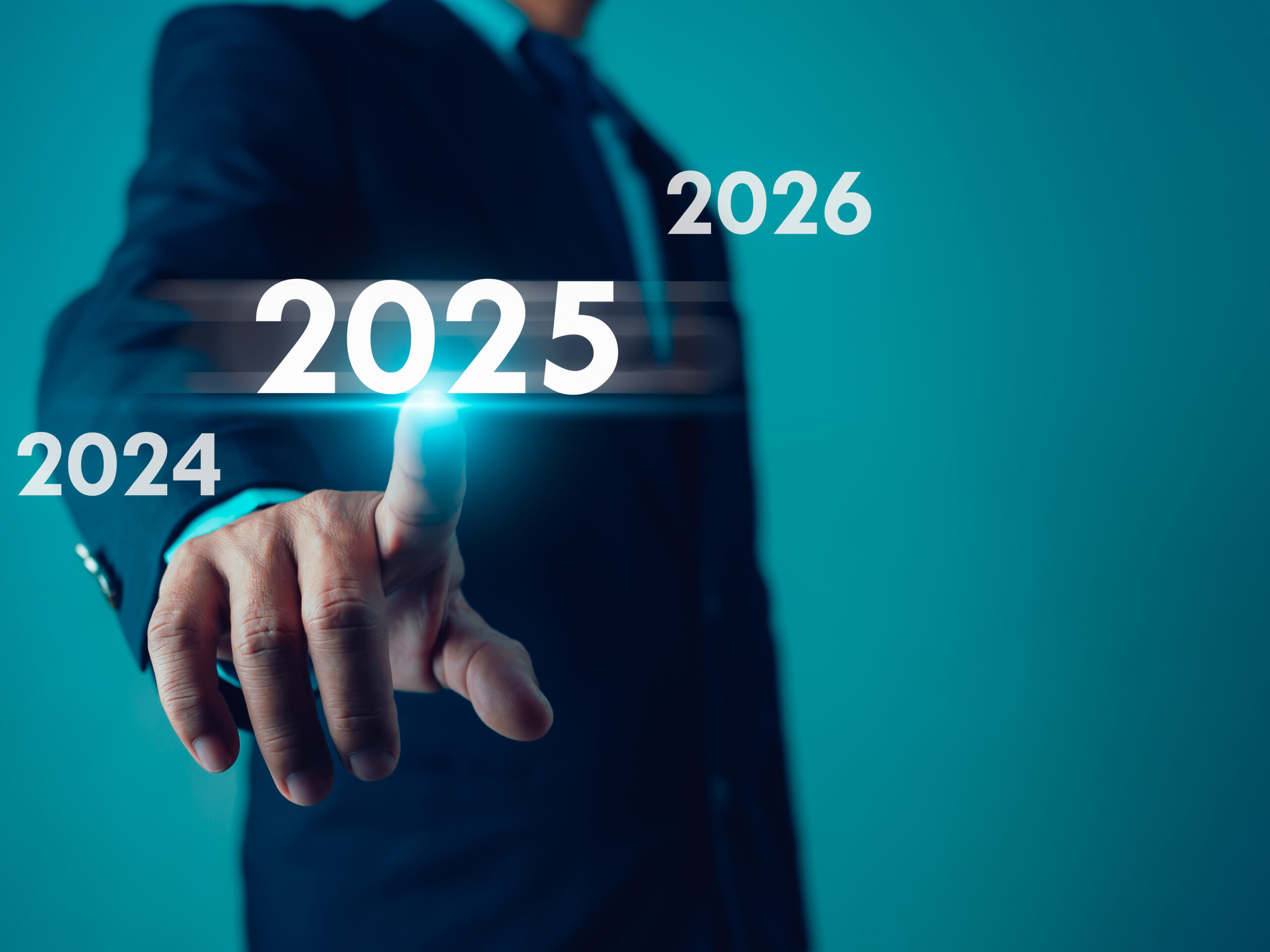 Man in suit pointing at the year 2025