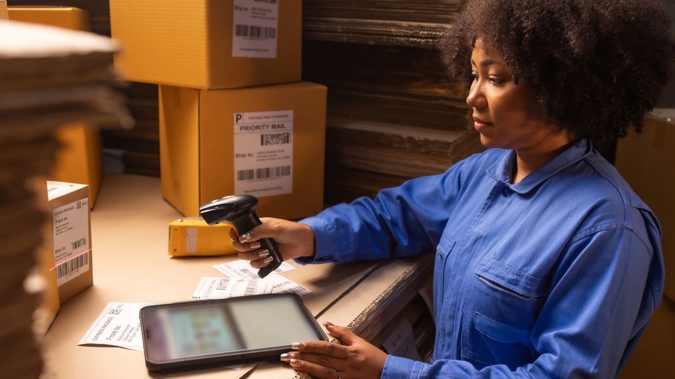 A logistics worker using a tablet scanner to track assets with an rfid heat resistant system. 2. RFID Tags Close-Up
